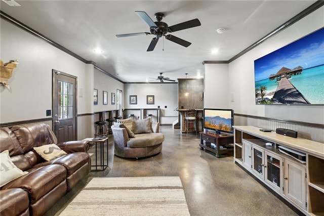 living room with ornamental molding and ceiling fan