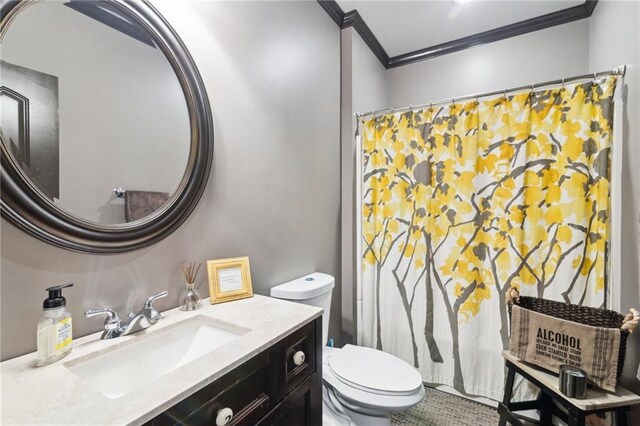 bathroom with crown molding, vanity, and toilet