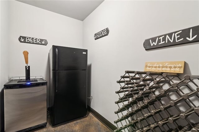 interior space featuring black refrigerator and stainless steel fridge