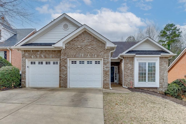 view of front of home with a garage, concrete driveway, brick siding, and roof with shingles