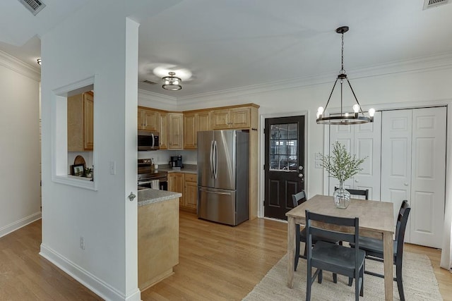 kitchen featuring stainless steel appliances, light wood-style flooring, light countertops, and visible vents