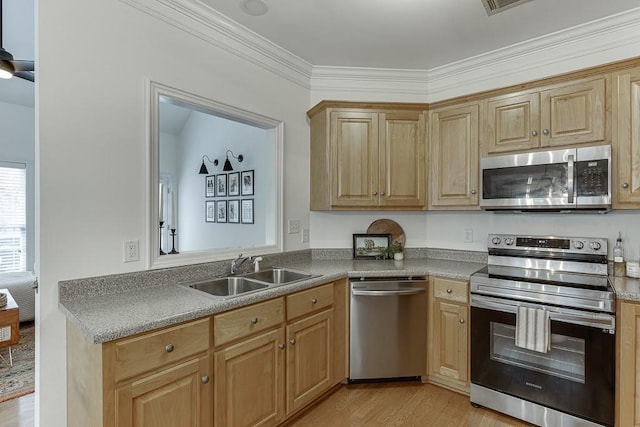 kitchen with light wood-style flooring, stainless steel appliances, a sink, light brown cabinetry, and crown molding