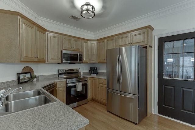 kitchen featuring stainless steel appliances, visible vents, light brown cabinetry, light wood-style floors, and a sink