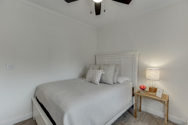 carpeted bedroom featuring baseboards, ceiling fan, and crown molding