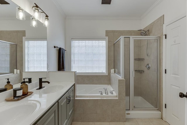 bathroom featuring a sink, ornamental molding, a shower stall, and a bath