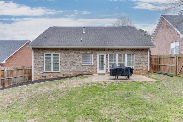 back of property featuring a fenced backyard, a patio, a lawn, and brick siding