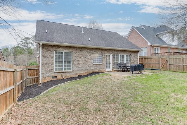 back of property featuring a yard, brick siding, crawl space, and roof with shingles