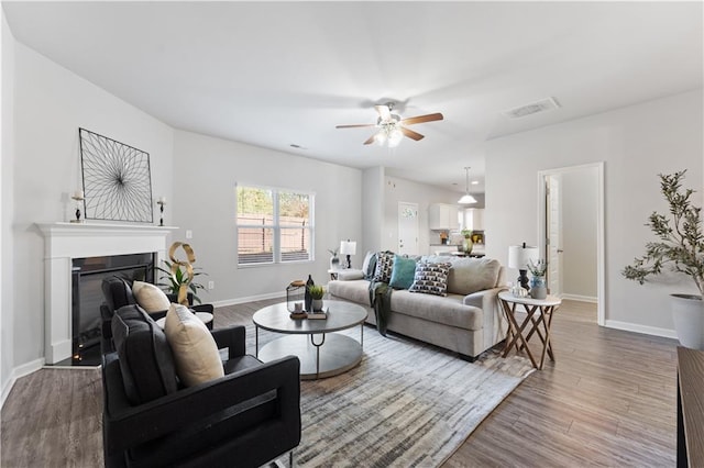 living room featuring hardwood / wood-style flooring and ceiling fan