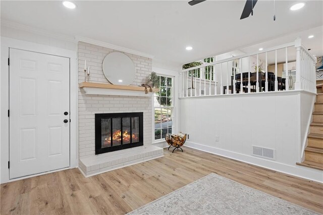 4745 Elam Forest Dr, Stone Mountain, GA 30083 - living room with a ceiling fan, crown molding, wood finished floors, a fireplace, and stairs