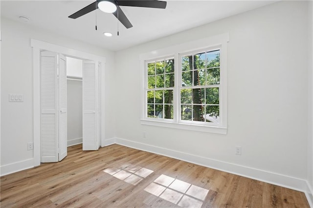 4745 Elam Forest Dr, Stone Mountain, GA 30083 - unfurnished bedroom with baseboards, light wood-style flooring, a closet, and ceiling fan