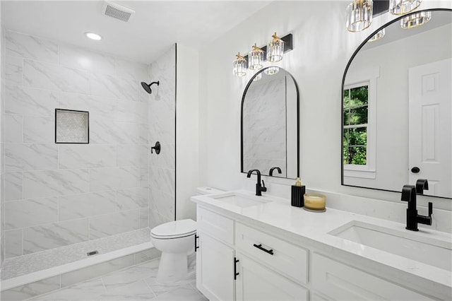 4745 Elam Forest Dr, Stone Mountain, GA 30083 - full bath featuring toilet, marble look tiles, double vanity, tiled shower, and a chandelier