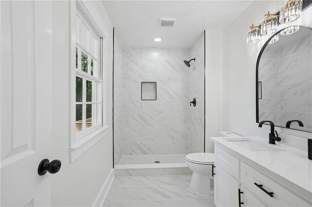 4745 Elam Forest Dr, Stone Mountain, GA 30083 - full bath with baseboards, toilet, vanity, marble finish floors, and a tile shower