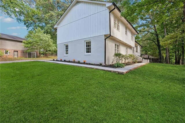 4745 Elam Forest Dr, Stone Mountain, GA 30083 - view of side of home with a yard and brick siding