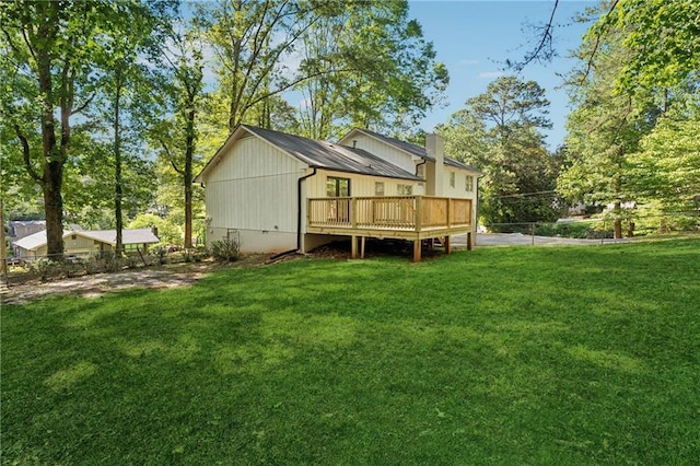 4745 Elam Forest Dr, Stone Mountain, GA 30083 - rear view of property featuring a chimney, a wooden deck, and a yard