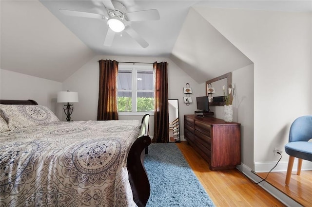 bedroom with baseboards, wood finished floors, ceiling fan, and vaulted ceiling