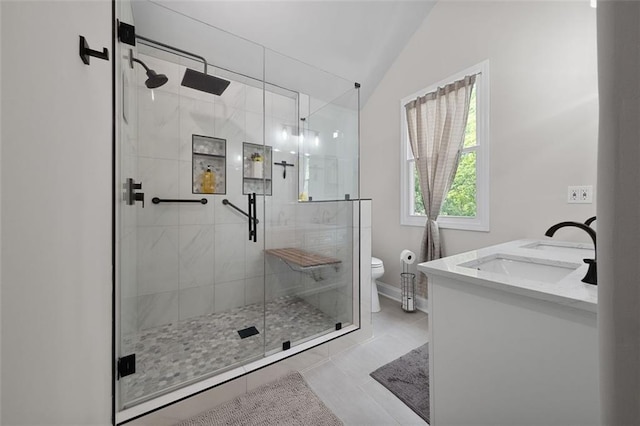 full bath featuring a sink, a shower stall, toilet, baseboards, and lofted ceiling