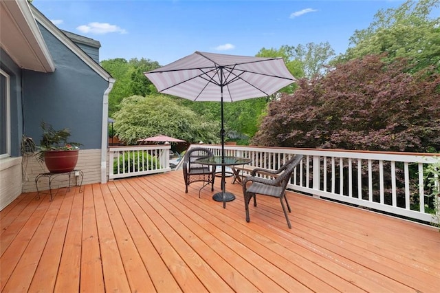 wooden terrace featuring outdoor dining area