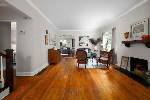 living room with a fireplace, visible vents, wood-type flooring, and arched walkways