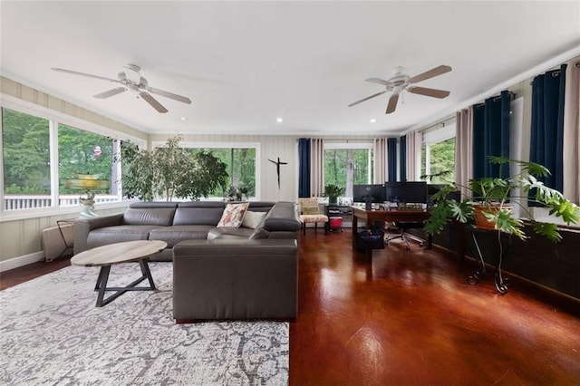 living area with a wealth of natural light, ornamental molding, and a ceiling fan