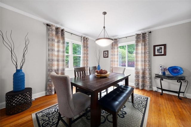 dining space featuring baseboards, ornamental molding, and a wealth of natural light