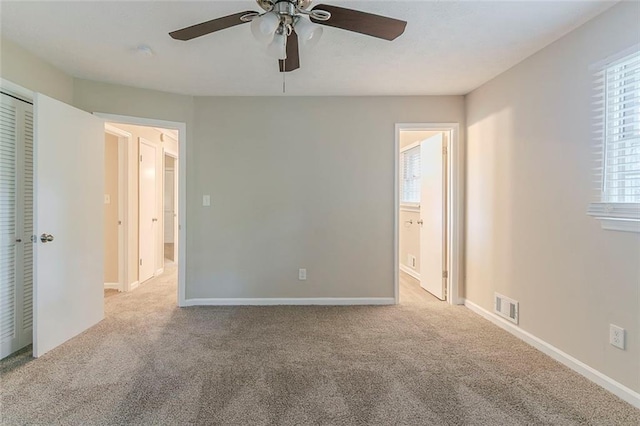545 Fayetteville Rd, Fairburn, GA 30213 - unfurnished bedroom with carpet, connected bathroom, ceiling fan, and baseboards