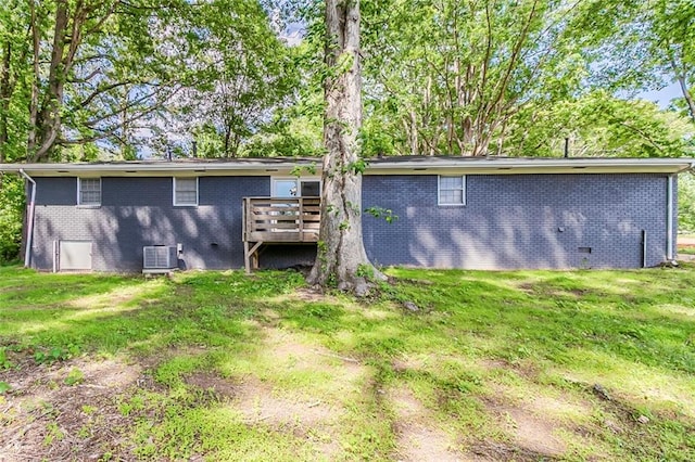 545 Fayetteville Rd, Fairburn, GA 30213 - back of property featuring brick siding, a wooden deck, a lawn, and crawl space
