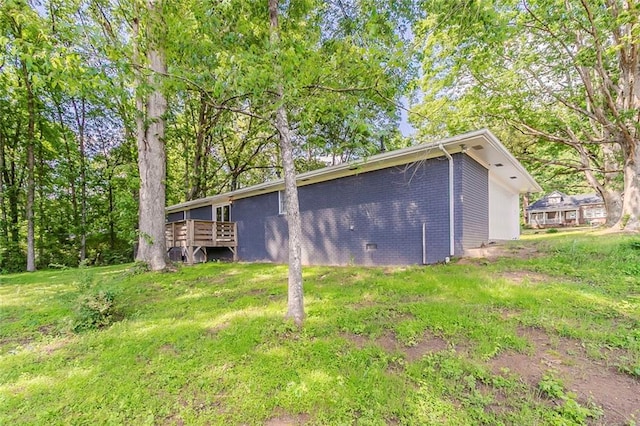545 Fayetteville Rd, Fairburn, GA 30213 - view of side of property featuring brick siding, a deck, and a lawn