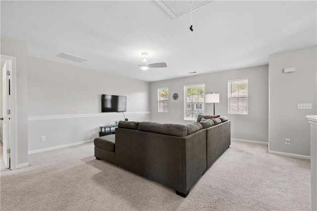 living room featuring ceiling fan and light colored carpet