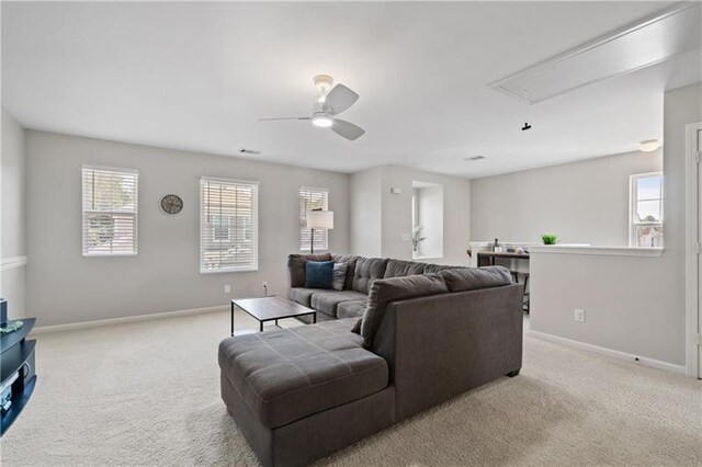 carpeted living room featuring ceiling fan