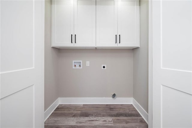 clothes washing area featuring cabinet space, baseboards, wood finished floors, washer hookup, and electric dryer hookup