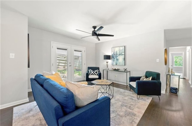 living room featuring ceiling fan, dark hardwood / wood-style floors, and french doors