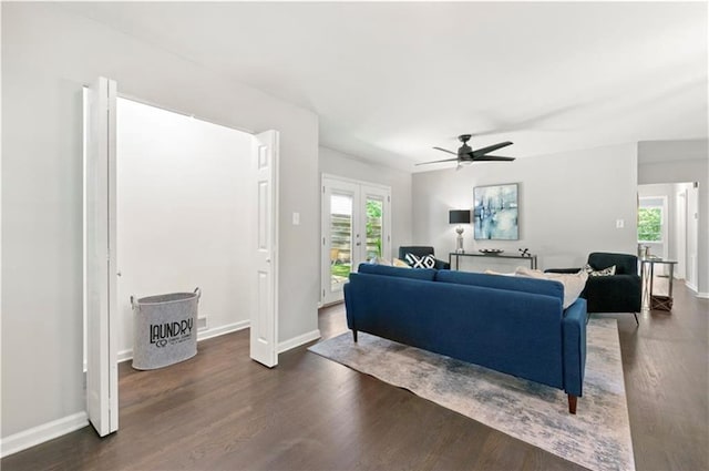 living room featuring french doors, ceiling fan, and dark wood-type flooring