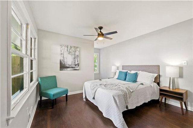 bedroom with ceiling fan and dark hardwood / wood-style flooring