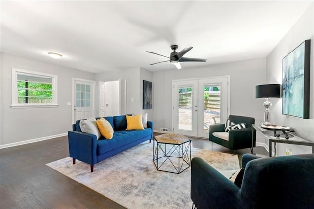 living room with ceiling fan, a healthy amount of sunlight, dark hardwood / wood-style floors, and french doors