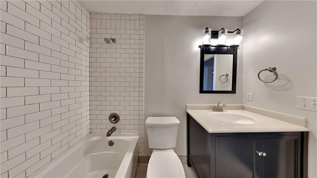 bathroom featuring toilet, shower / bathing tub combination, a textured ceiling, and vanity