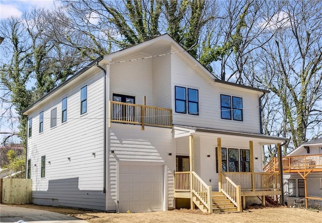 view of front of home with a garage, a balcony, and a porch