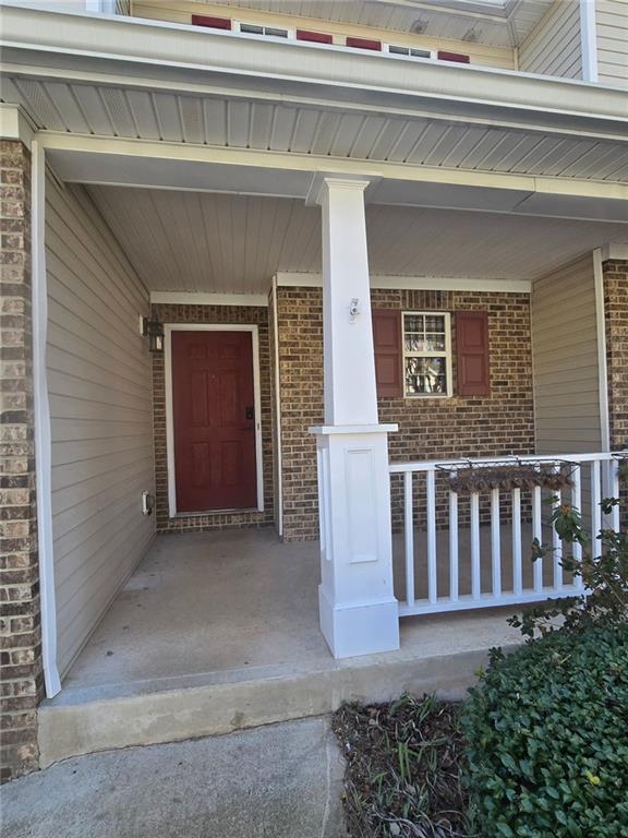 view of exterior entry with a porch