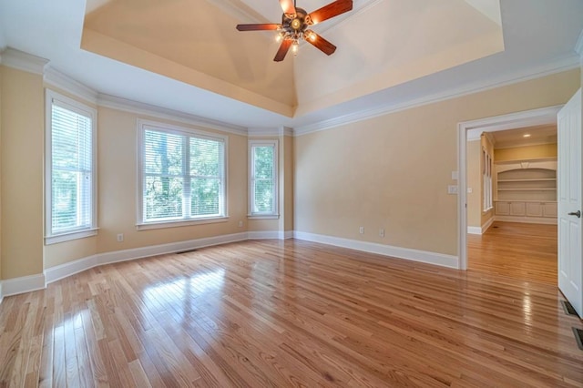 980 Windsor Place Cir, Grayson, GA 30017 - spare room featuring a raised ceiling, ornamental molding, light wood finished floors, a ceiling fan, and baseboards