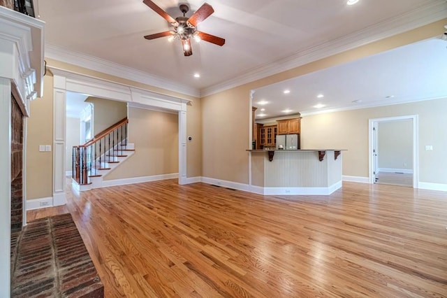 980 Windsor Place Cir, Grayson, GA 30017 - unfurnished living room with light wood-type flooring, a ceiling fan, recessed lighting, stairs, and ornamental molding