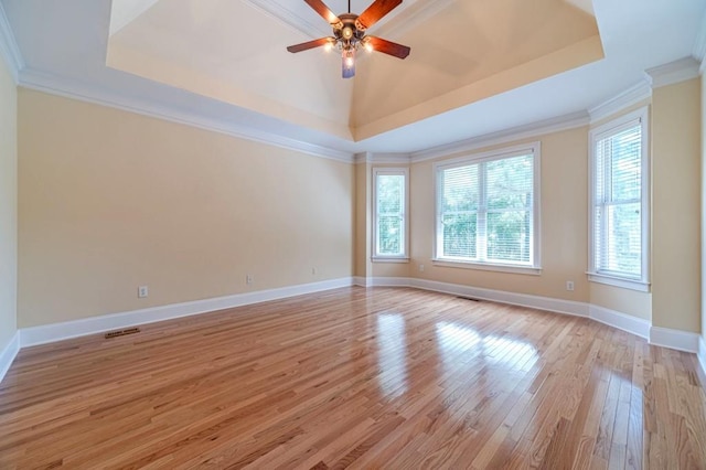 980 Windsor Place Cir, Grayson, GA 30017 - spare room featuring a raised ceiling, light wood finished floors, ceiling fan, crown molding, and baseboards