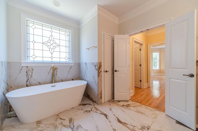 980 Windsor Place Cir, Grayson, GA 30017 - full bathroom featuring a soaking tub, marble tiled flooring, wainscoting, and ornamental molding