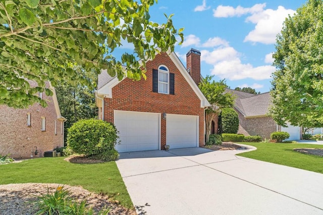 980 Windsor Place Cir, Grayson, GA 30017 - traditional-style house featuring brick siding, driveway, a chimney, and a front yard