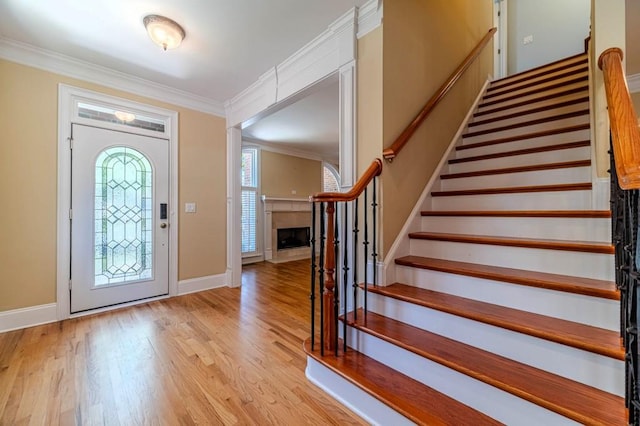 980 Windsor Place Cir, Grayson, GA 30017 - foyer featuring stairs, ornamental molding, light wood-type flooring, baseboards, and a fireplace