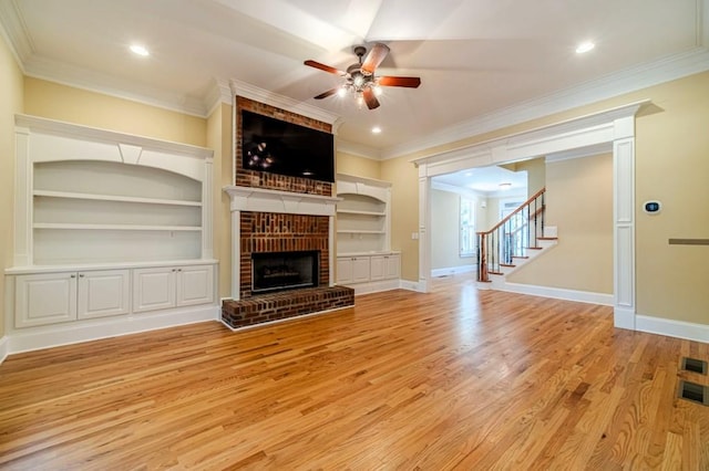 980 Windsor Place Cir, Grayson, GA 30017 - unfurnished living room featuring a ceiling fan, light wood-style floors, stairs, a fireplace, and baseboards