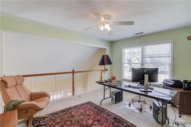 office space featuring ceiling fan and light carpet