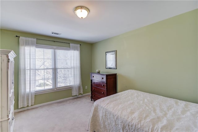 bedroom featuring light colored carpet