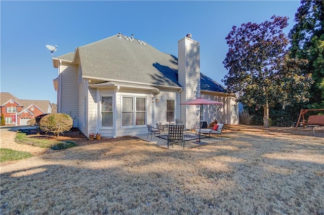 rear view of property with a patio and a yard