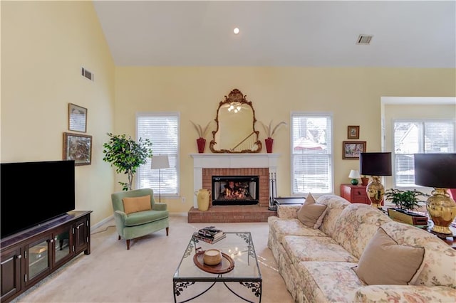 living room with light carpet, a fireplace, and vaulted ceiling