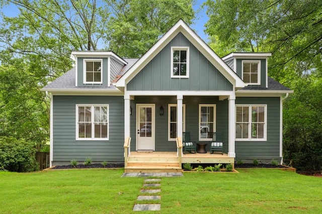 2760 Fraser St SE, Smyrna, GA 30080 - view of front of house with covered porch, a front lawn, board and batten siding, and a shingled roof