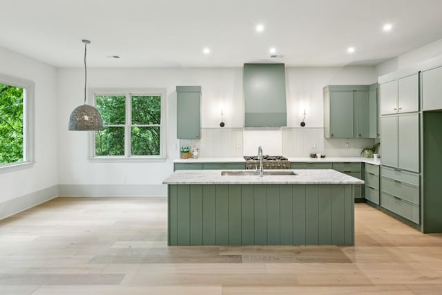 2760 Fraser St SE, Smyrna, GA 30080 - kitchen with green cabinetry, wall chimney exhaust hood, a sink, an island with sink, and recessed lighting